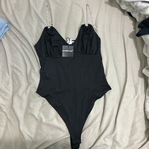 Charolette russ, black bodysuit